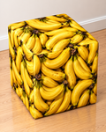 Banana square printed ottoman covered in a vibrant pattern of yellow bananas
